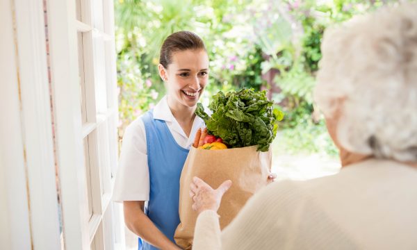 14558207-nice-nurse-bringing-vegetables-to-old-patient