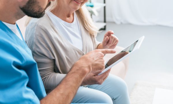 28015365-cropped-shot-of-male-nurse-and-senior-woman-using-digital