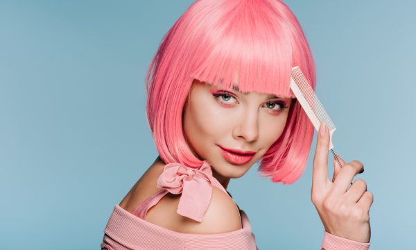 29247534-attractive-girl-in-pink-wig-posing-with-hair-comb
